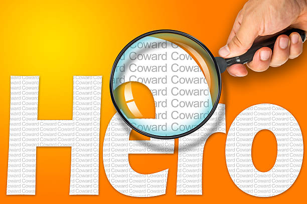 istock HERO - COWARD Opposite message, Hand holding magnifying glass 480724132