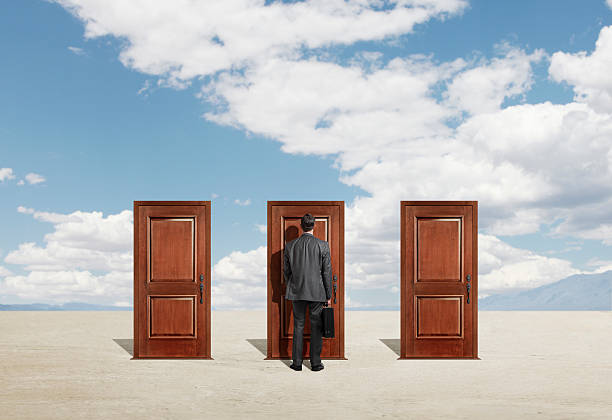 istock Businessman standing in front of three closed doors 480725941