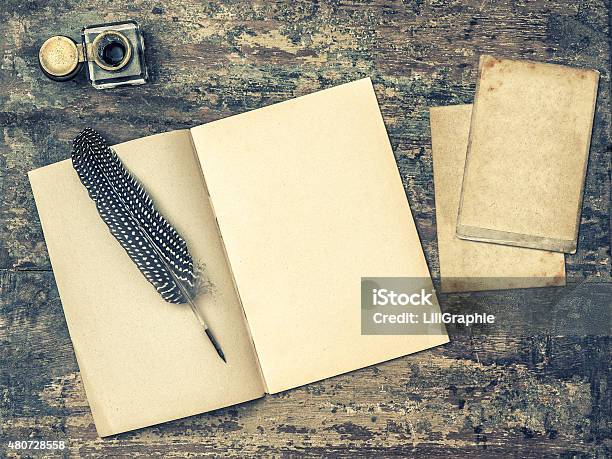 Open Book Antique Writing Tools Feather Pen And Inkwell Stock Photo - Download Image Now