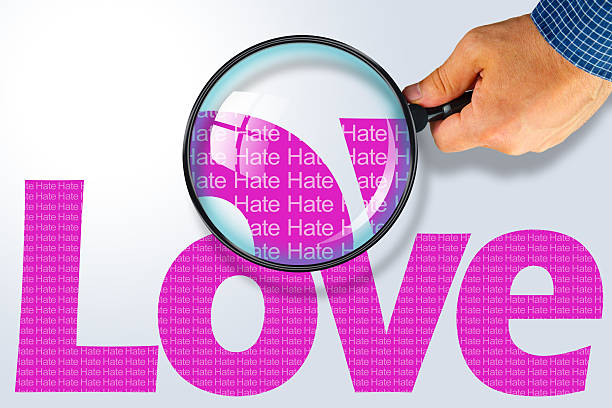 istock LOVE - HATE Opposite message, Hand holding magnifying glass 480729060