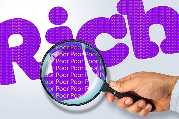 istock RICH - POOR Opposite message, Hand holding magnifying glass 480729308