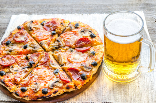 Homemade pizza with a glass of beer