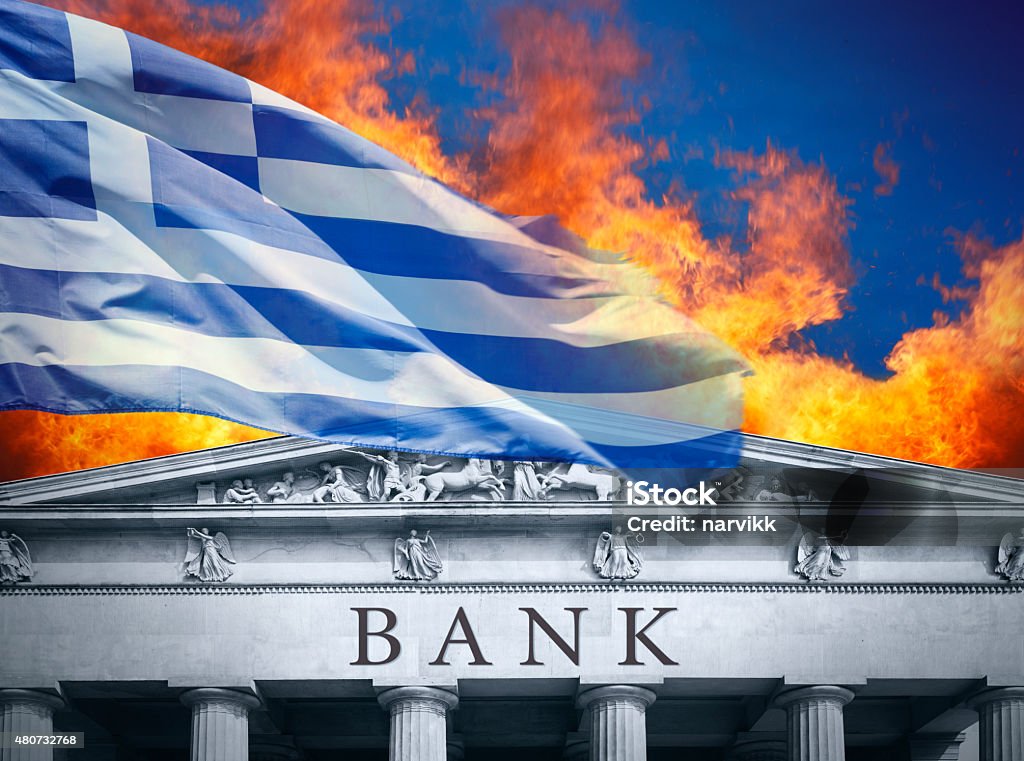 The banking crisis in Greece Burning bank with Greek flag above 2015 Stock Photo