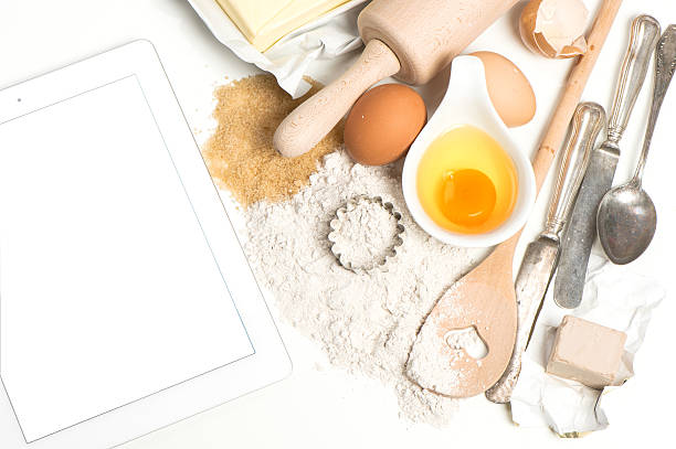 istock Tablet pc and baking ingredients eggs, flour, sugar, butter, yeast 480733220