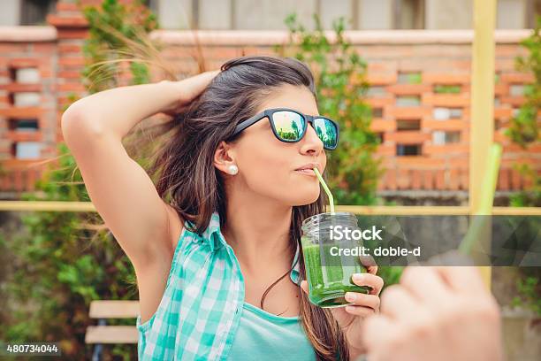 Woman With Sunglasses Drinking Green Vegetable Smoothie Outdoors Stock Photo - Download Image Now