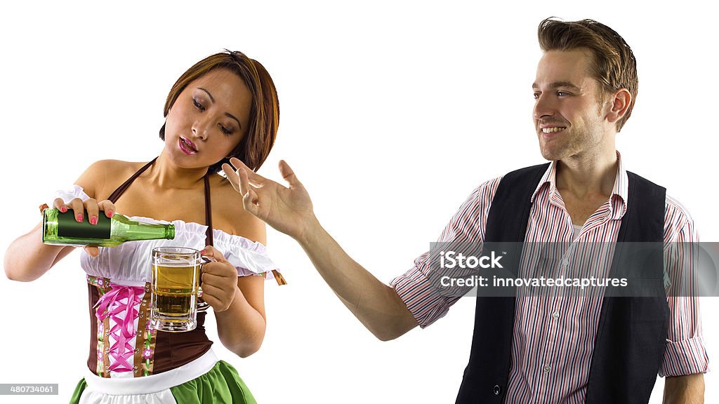 Tempted with Beer By A Waitress on Saint Patricks Day young female dressed in St Patty's costume serving customers Adult Stock Photo