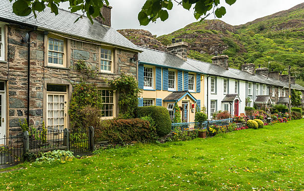 Welsh Cottages Cottages in the village of Beddgelert, Snowdonia with hills in the background. snowdonia national park stock pictures, royalty-free photos & images