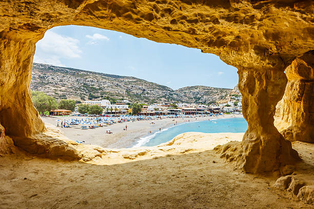 Matala beach, Crete island, Greece Matala beach, view from a cave in cliff used by hippies, Crete island, Greece. crete stock pictures, royalty-free photos & images