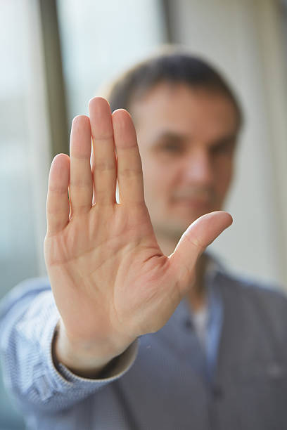 istock man in shirt showing his palm, closeup 480738122