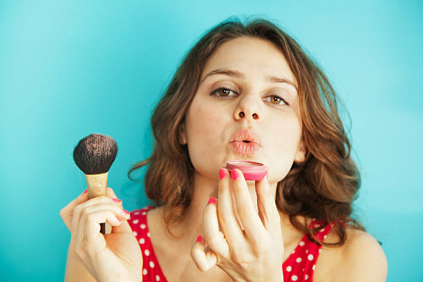 istock beautiful girl with a brush and blusher 480738471