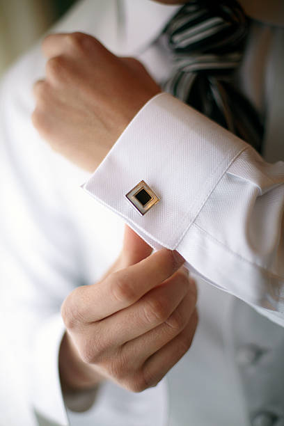 istock Groom tying an elegant cufflink in his wedding shirt 480738813