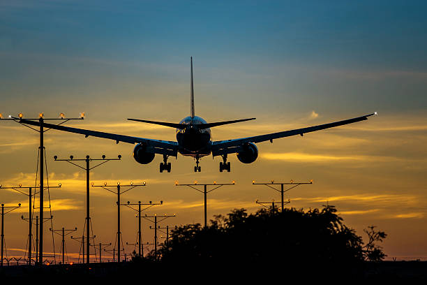 istock Vibrant_sky_colors_airplane_landing_at_sunset 480739327