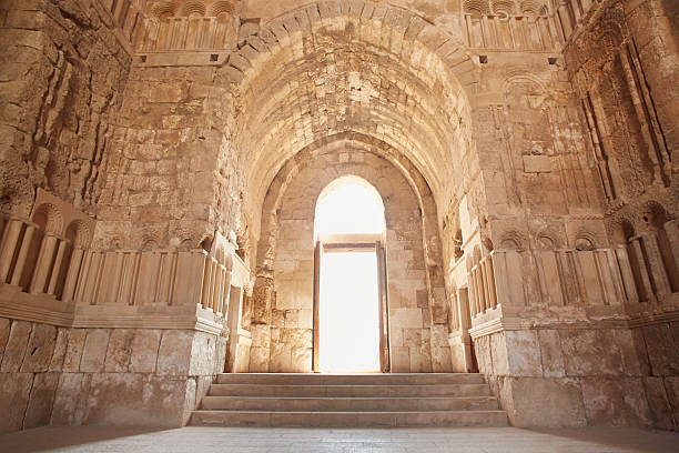 Gothic archway with light illuminating the path.