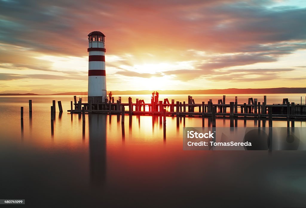 Beach sunrise with lighthouse Beach sunset with lighthouse Neusiedlersee Stock Photo