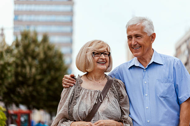 Mature Couple Enjoying Afternoon And Walking Through The City
