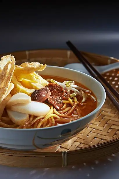 Malaysia favorite spicy noodle laksa with fish cake and cockle