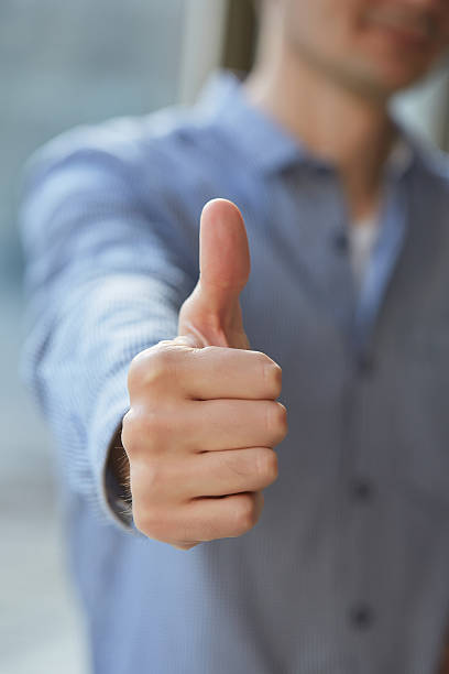 istock man in shirt shows thumb closeup 480743094