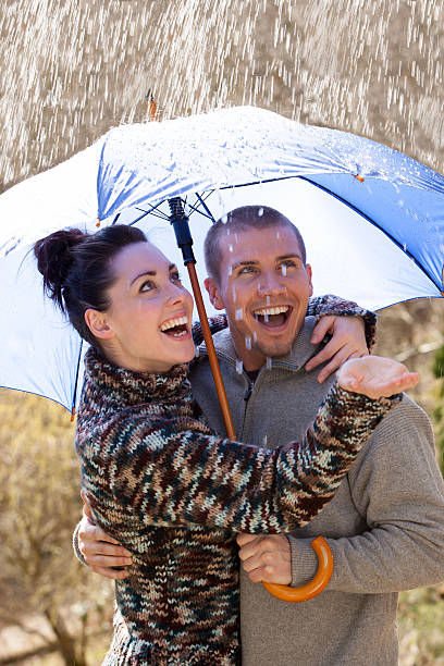 istock Young couple playing in the rain 480743322