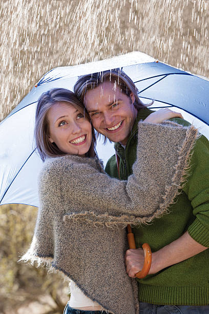 istock Couple smiling in the rain 480743338