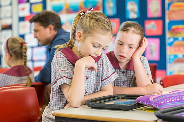 istock Happy School Girls Using Tablet Computers In The Classroom 480743734