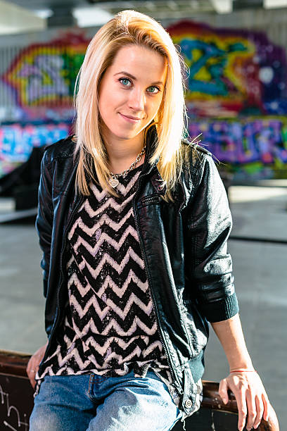 istock blonde in skate park is playing with her hair 480746982