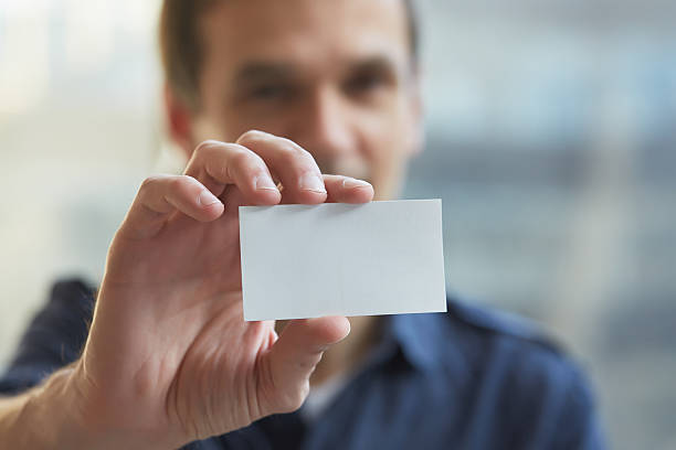 istock businessman giving a business card 480747282