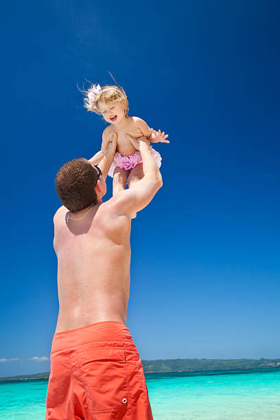 istock Happy father and little child on beach 480747375