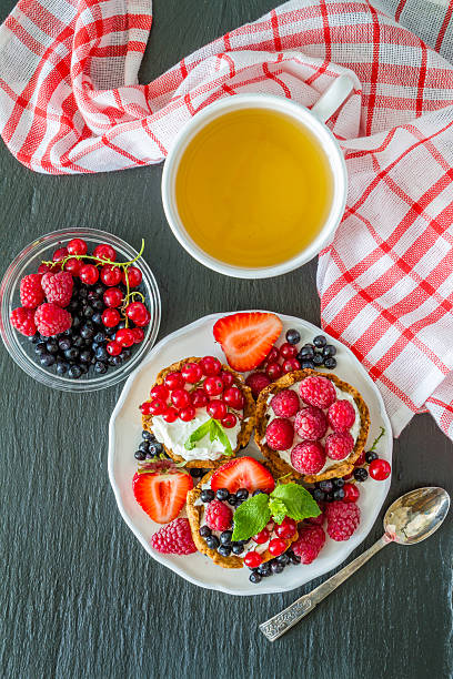 istock Berry cakes, dark stone background, top view 480747420