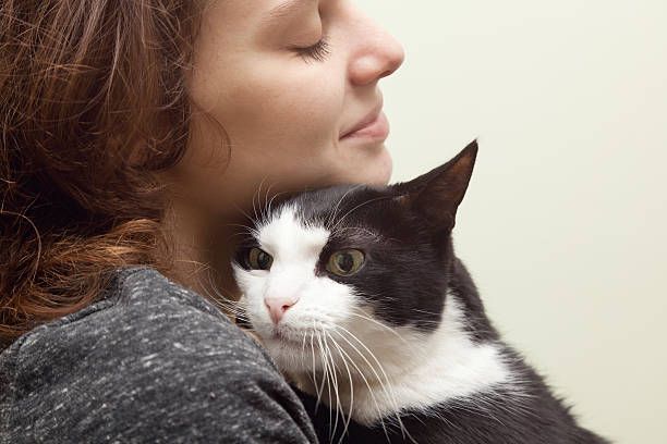 istock beautiful young woman with a cat 480747611