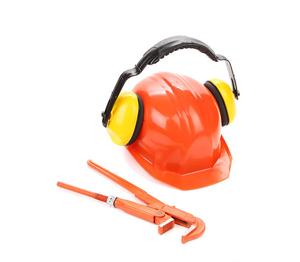 istock Protective helmet with headphones and wrench key. 480749793
