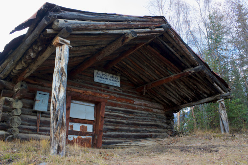 Old closed wooden post office cabin in Wiseman, Alaska