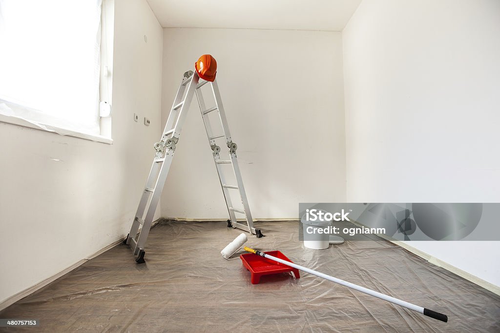 Painting Tools in an Empty Room Prepared for Renovation Several painting tools prepared for painting a room. Preparation Stock Photo