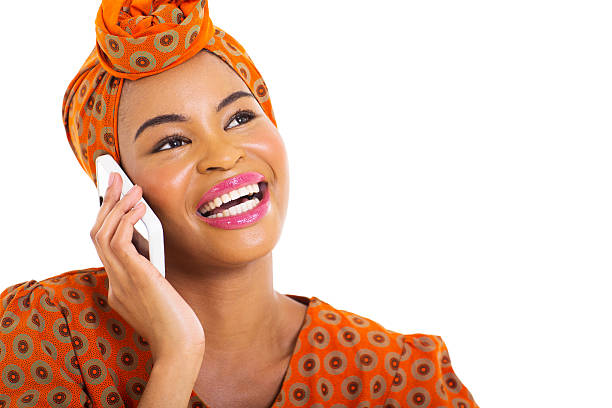 beautiful young african woman talking on her cell phone over white background
