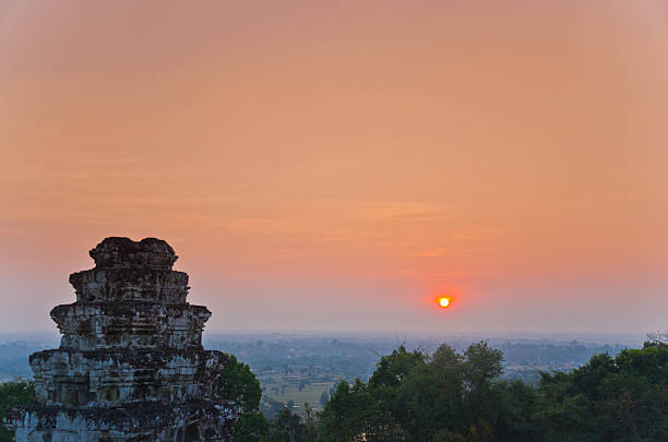 sun set over the jungle and some ruins at Angkor Wat Area in Cambodia