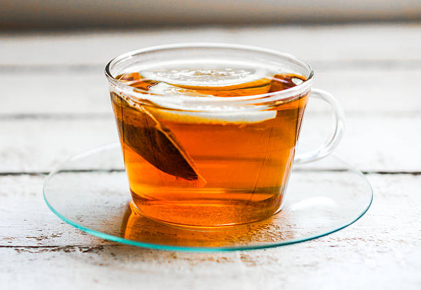 istock Tea cup with lemon and cookies on rustic wooden background 480760223