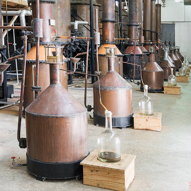 destillation von rosenöl - distillation tower stock-fotos und bilder