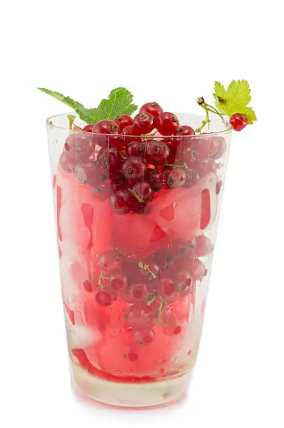 Photo of Currant ice tea in a glass with fresh currant isolated