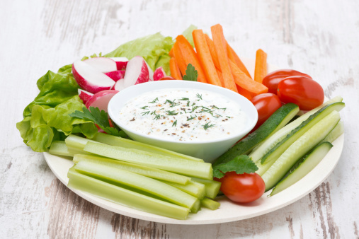 plate with fresh vegetables and thick yoghurt sauce, horizontal
