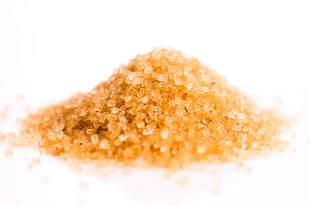 istock Crystals cane sugar heap close up isolated on white 480768282