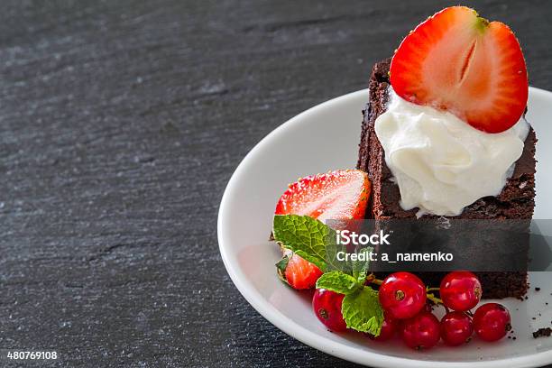 Brownie With Nuts Chocolate Mint Stawberry Dark Stone Background Stock Photo - Download Image Now