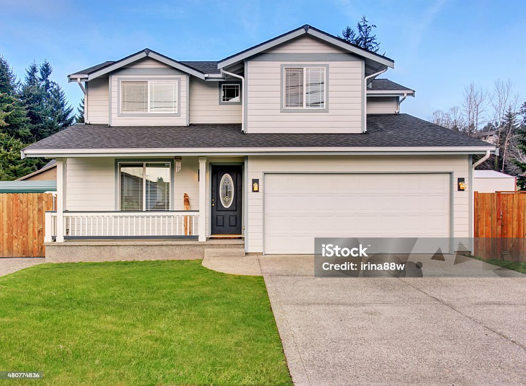 Traditional northwest home with driveway. Traditional northwest home with driveway and grass. 2015 Stock Photo