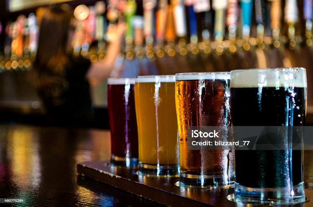 Flight of Craft Beer A flight of 4 craft beers lined up on the bar. Craft Beer Stock Photo