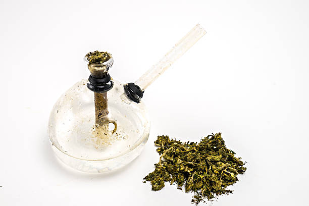 Dried Cannabis and glass bong , isolated on white Dried Cannabis and glass bong , isolated on white bong stock pictures, royalty-free photos & images