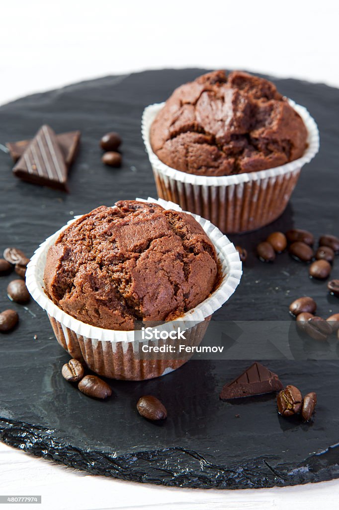 Chocolate muffins on a black tray Chocolate muffins on a black tray, selective focus 2015 Stock Photo