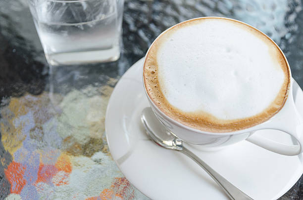 istock Cup of coffee on glass table 480779015