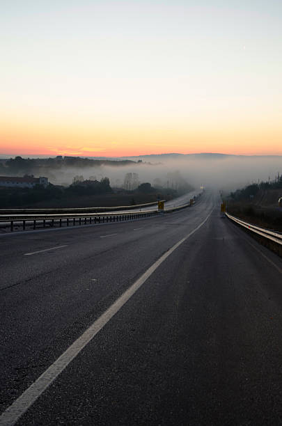 istock sunrise on a foggy road 480779332