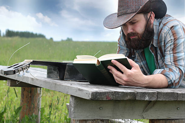 gitarrist in einen cowboy-hut auf die natur - cowboy blue meadow horizontal stock-fotos und bilder