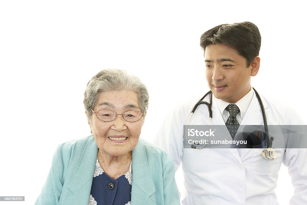 Smiling doctor and senior woman Smiling Asian medical doctor and senior woman Adult Stock Photo