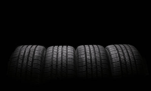 istock four automobile rubber tires isolated on black 480786374
