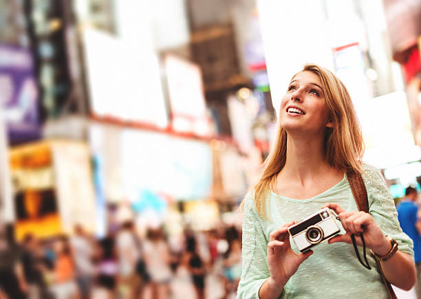 istock pretty woman smiling on times square 480788527